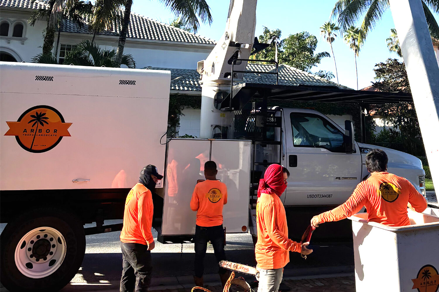 Arbor Tree and Landscape crew with branded work truck and equipment